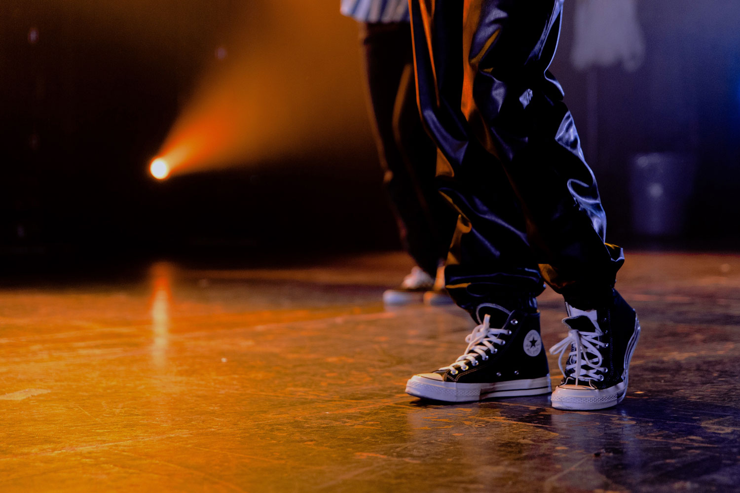 Person in sneakers on stage